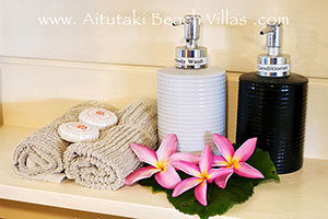 close-up of hand-towels, soap, cream and frangipani flowers