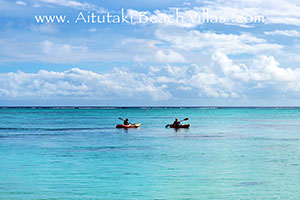 tourists on holiday in Aitutaki kayaking on turquoise lagoon